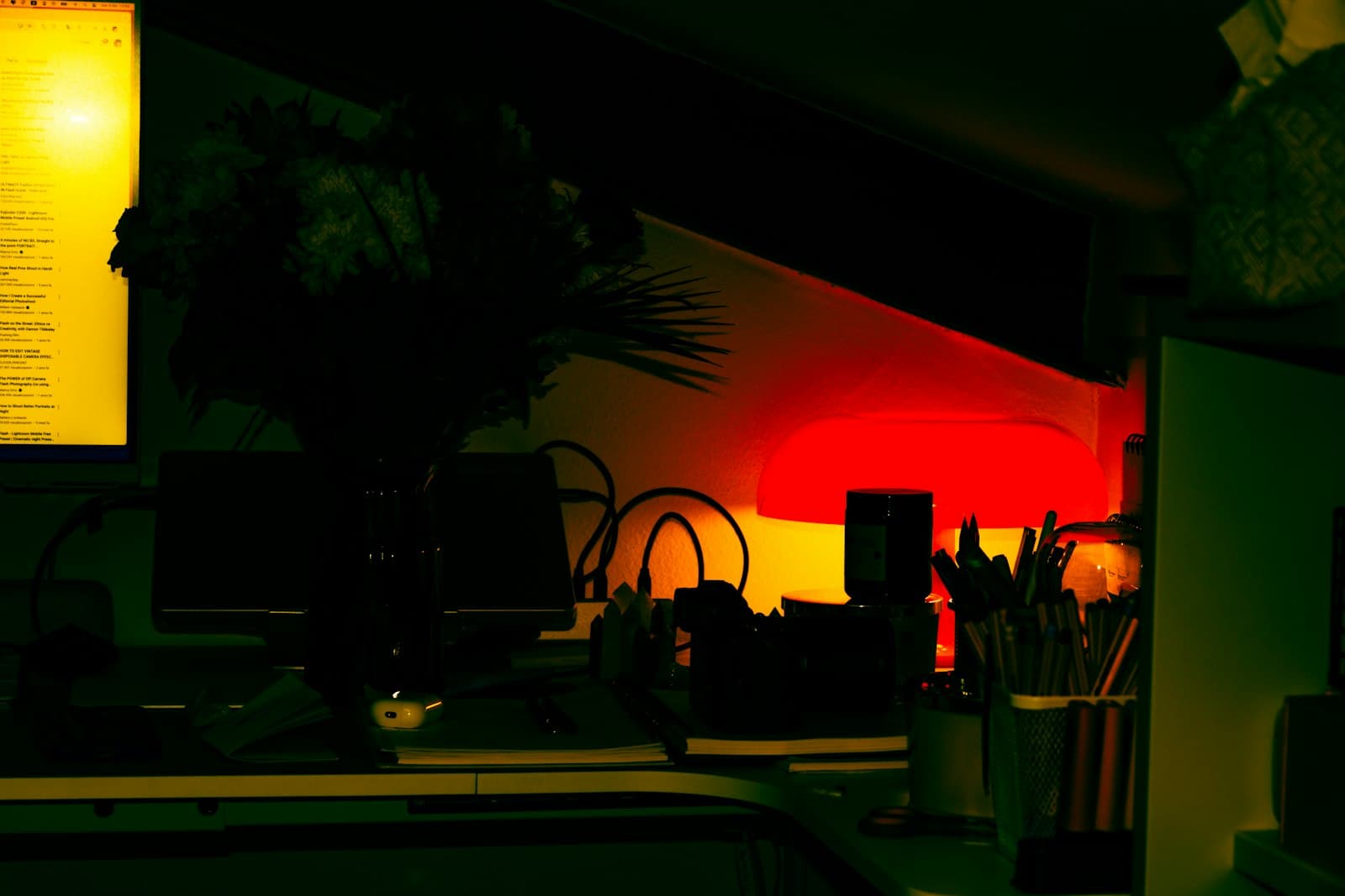 A quiet desk lit by a warm computer screen